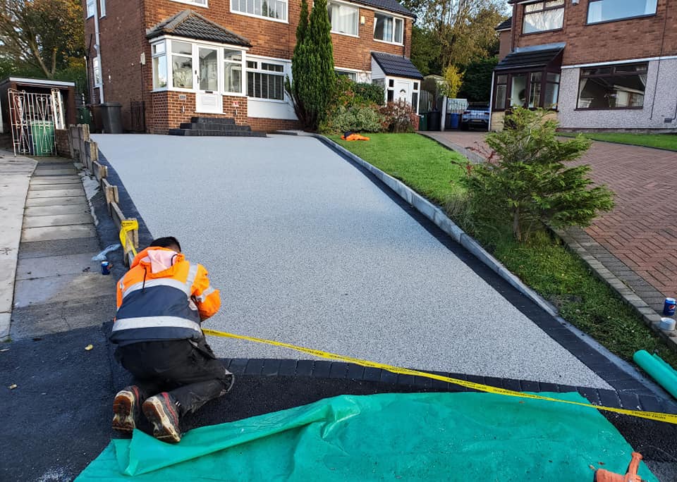 Imprinted concrete coating inspected before restoration
